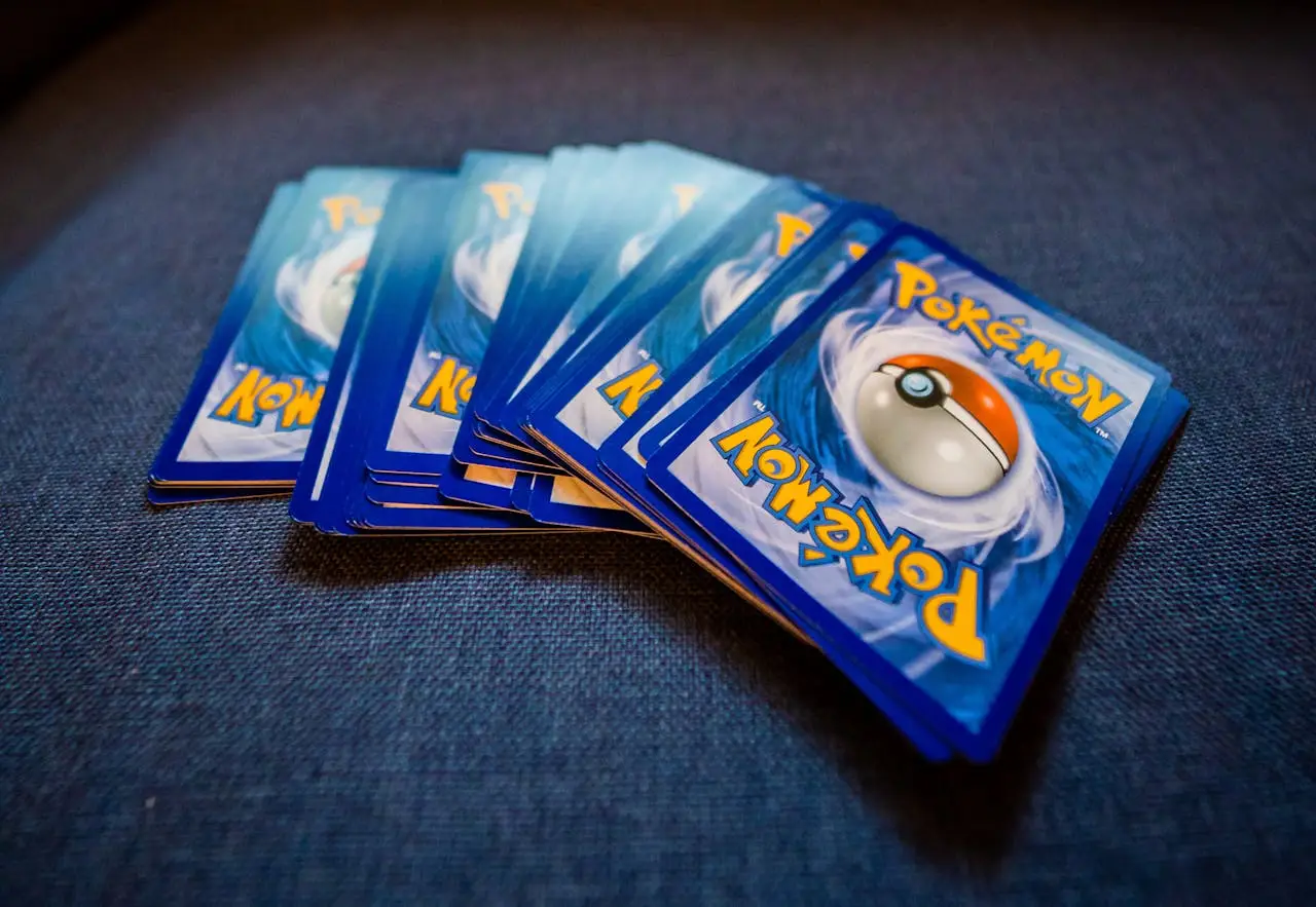 About From above of pack of collectible cards with images of fantastic creatures on backs located on gray backdrop