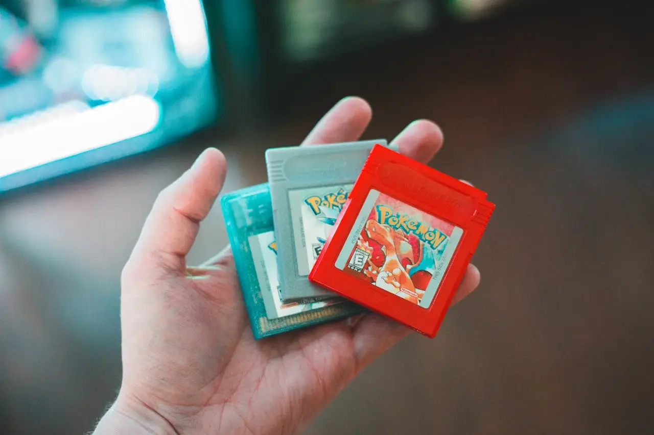 The Art of Drawing Readers In: Your attractive post title goes here Hand holding vintage Pokemon game cartridges, showcasing nostalgic gaming.